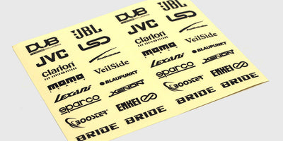 Arket med Stylez-klistermærker til fjernstyrede biler med forskellige logoer og symboler i sølv og sort.